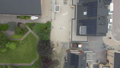 top down fly over of newly build houses on busy construction site