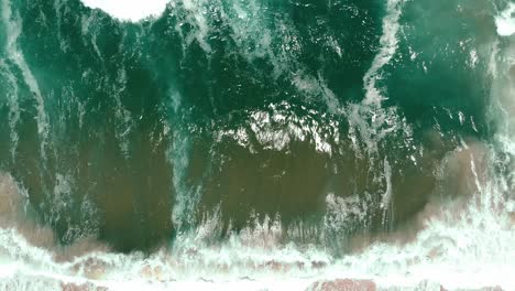 aerial drone showing endless wild sea breaking waves