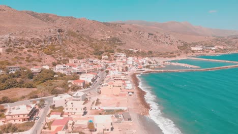 drone flying over small town i greece right by the water