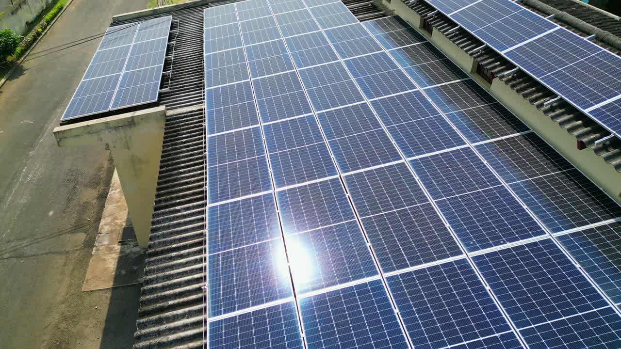 Fying over a solar panel roof with the sun reflecting off it in Sao Tome e Principe,Africa