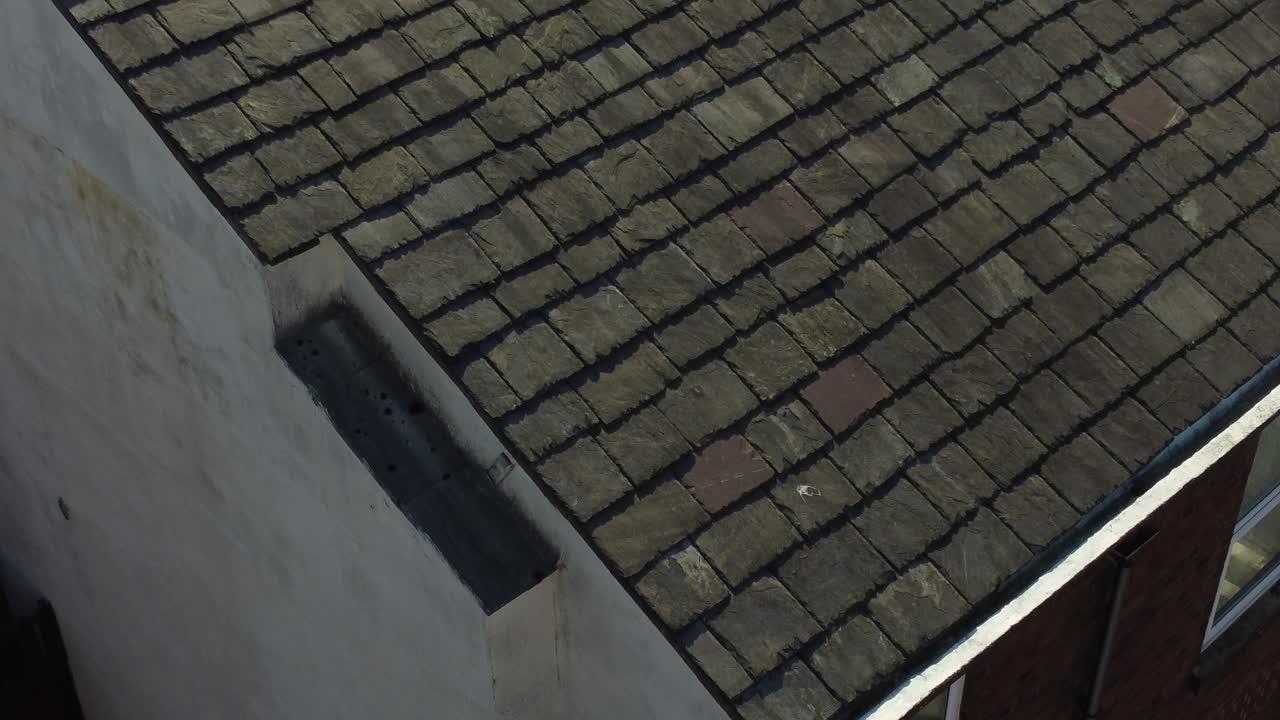 Rooftop inspection aerial view inspecting damage and repair of real estate for homeowner