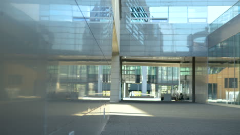 glass building facade with reflections and open space