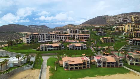 toma aérea de un hotel y una villa frente a la playa en cabo san lucas méxico