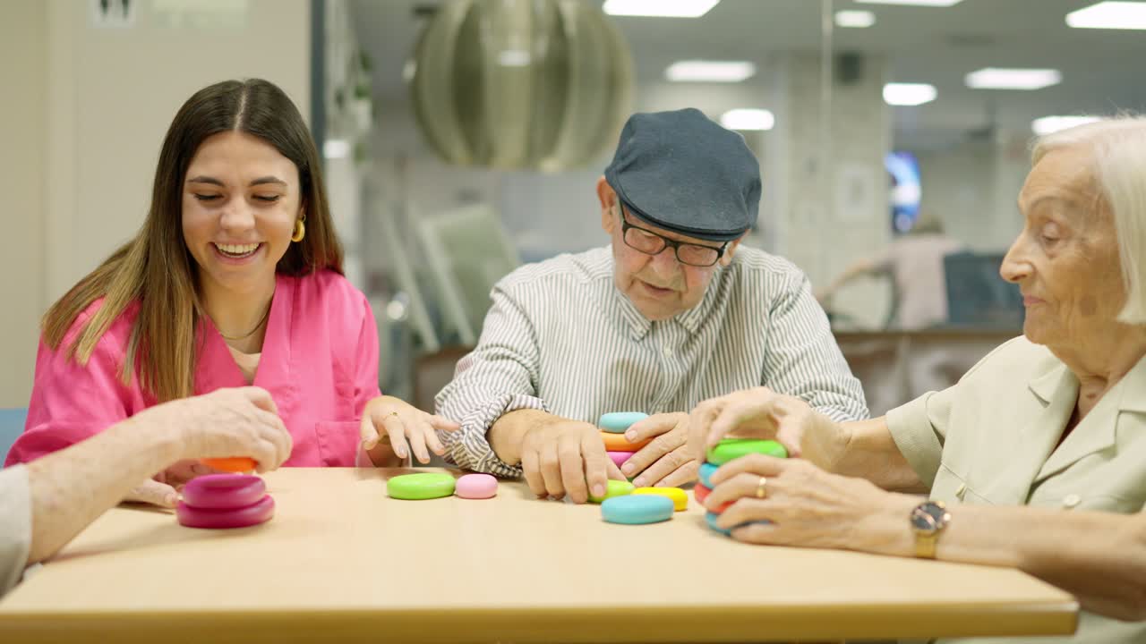 Seniors playing a game with a caretaker