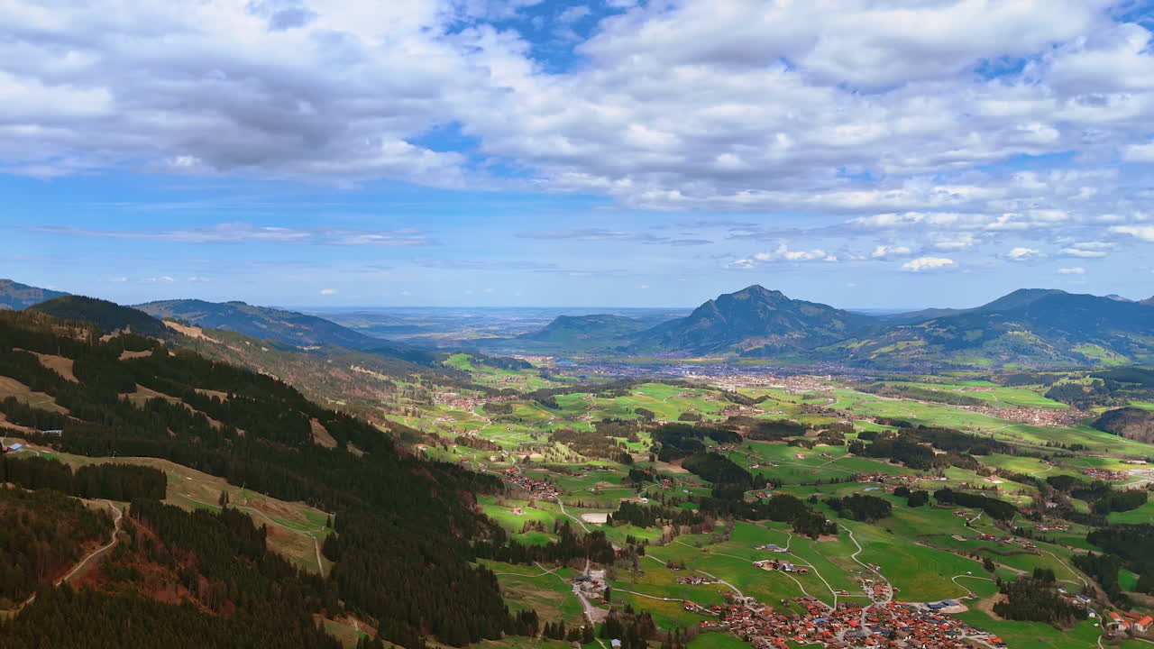 Amazing scenery of the vast valley with populated areas. Community of Bolsterlang, Bavaria, Germany located among the rocks. Aerial perspective.
