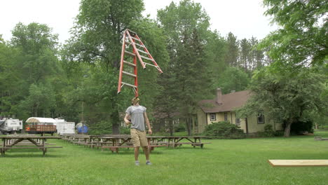 a man balances a six foot ladder on his chin with amazing skill in slow motion