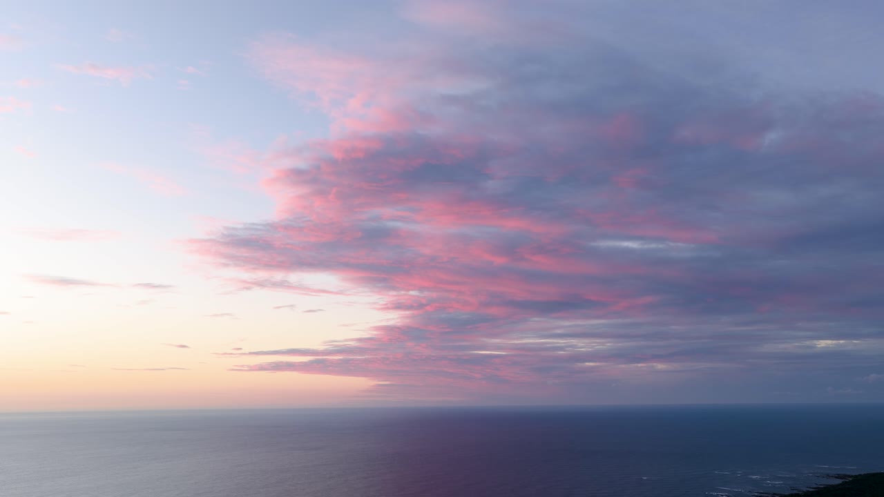 Sunset over the Ocean with Pink Clouds
