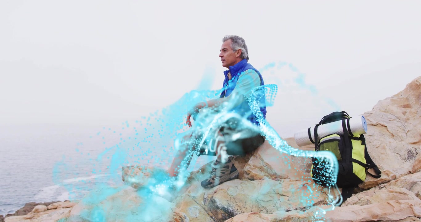Hiker gazing at sea and seeing energy ribbons emerging at feet swirling legs for health meditation