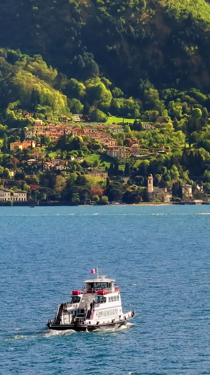 Aerial drone view hip navigating on Lake Como, Italy on a sunny day. Vertical