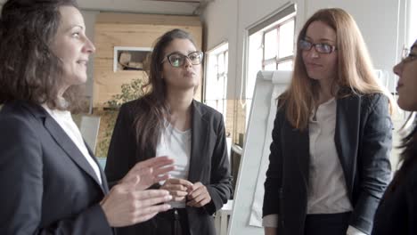 Concentrated-businesswomen-discussing-work