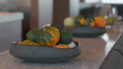 close up, bowls of mini squash pumpkins used for decorations in a restaurant for celebrating fall and halloween