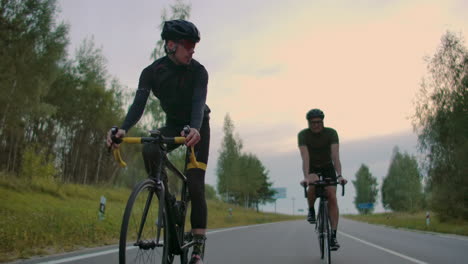 Cyclists-Riding-On-Country-Road