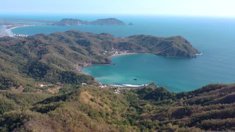 Stunning-aerial-view-of-mountains-and-blue-ocean-in-Mexico