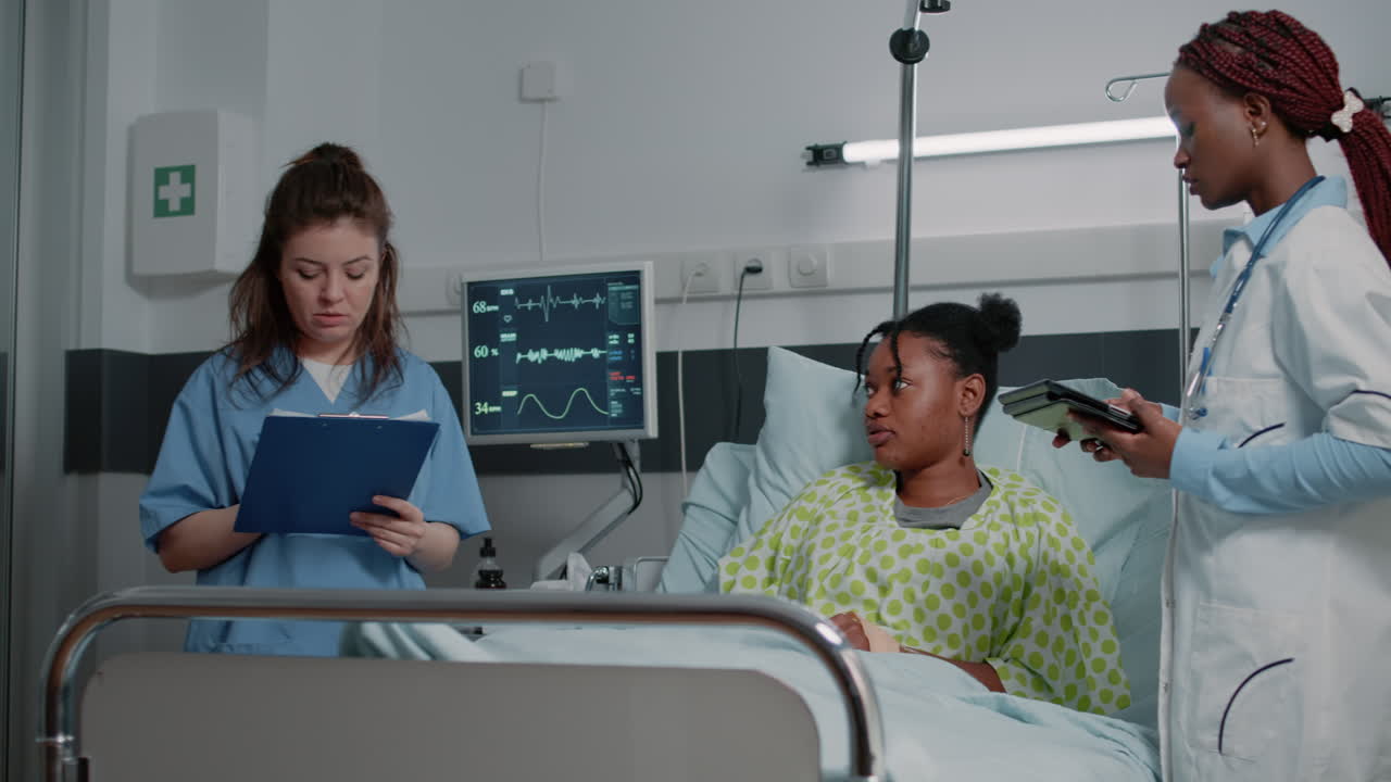 Multi ethnic team of specialists consulting patient with illness