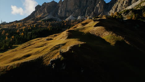 Aerial-Flying-Over-Val-Gardena-Valley-Trees-With-Golden-Sun-Light-Over-Rolling-Hillside