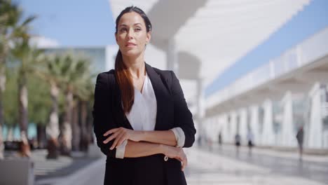 Thoughtful-businesswoman-with-folded-arms