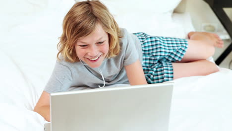 boy listening to music on his laptop