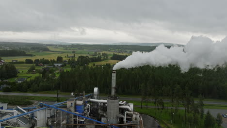 factory in norwegian countryside emits harmful greenhouse gases, aerial arc