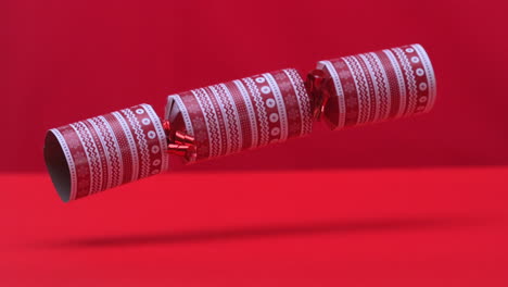 christmas cracker dropping and bouncing on red background