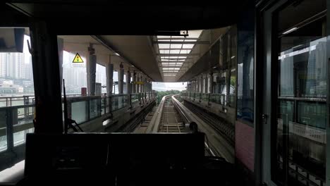 clip from inside a traintram on rails leaving a station in the city of chongqing in china