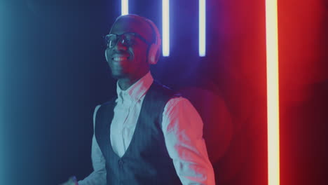 man dancing to music in neon lights