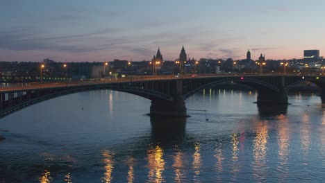 Sunset-aerial-drone-shot-very-low-of-the-city-of-Mainz-showing-the-Dome-in-the-heart-of-the-city-center-in-best-golden-hour-light-with-red-glow-on-the-sky-with-a-Drohne-City-if-Biontech