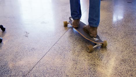 executive skateboarding in office