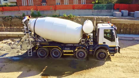 one worker fixing the cement mixer on housing project