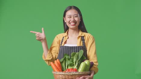 woman holding basket of vegetables