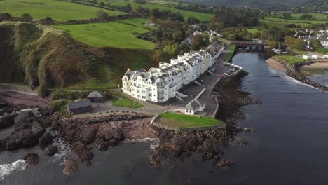 Aerial-view-of-Cushendun-village-on-a-sunny-day,-County-Antrim,-Northern-Ireland