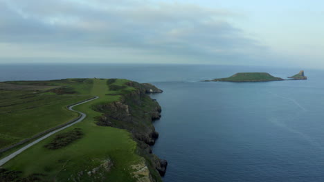 Drone-aerial-footage-of-huge-cliffs-in-Rhossili-bay-in-Gower-peninsula,-Swansea-in-South-Wales