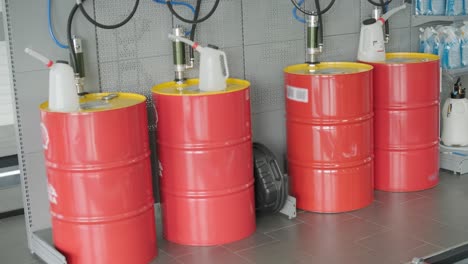 oil barrels and maintenance equipment in a repair shop