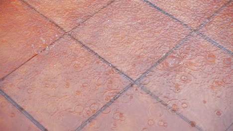 heavy rain falling on the brown tile floor