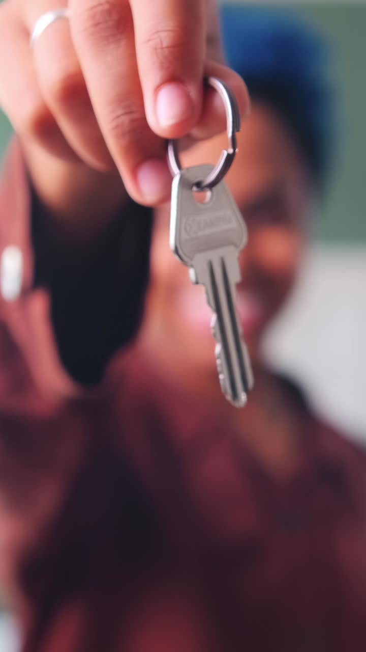 Young happy blurred african american woman shows keys to apartment