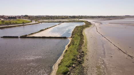 4K-aerial-view-of-the-saline’s-of-Aveiro,-drone-flying-over-a-section-of-the-salt-farm,-60fps