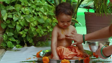 cute toddler baby boy bathing in decorated bathtub at outdoor from unique perspective