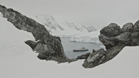 big expedition ship or boat sitting in a bay in antarctica, dolly shot