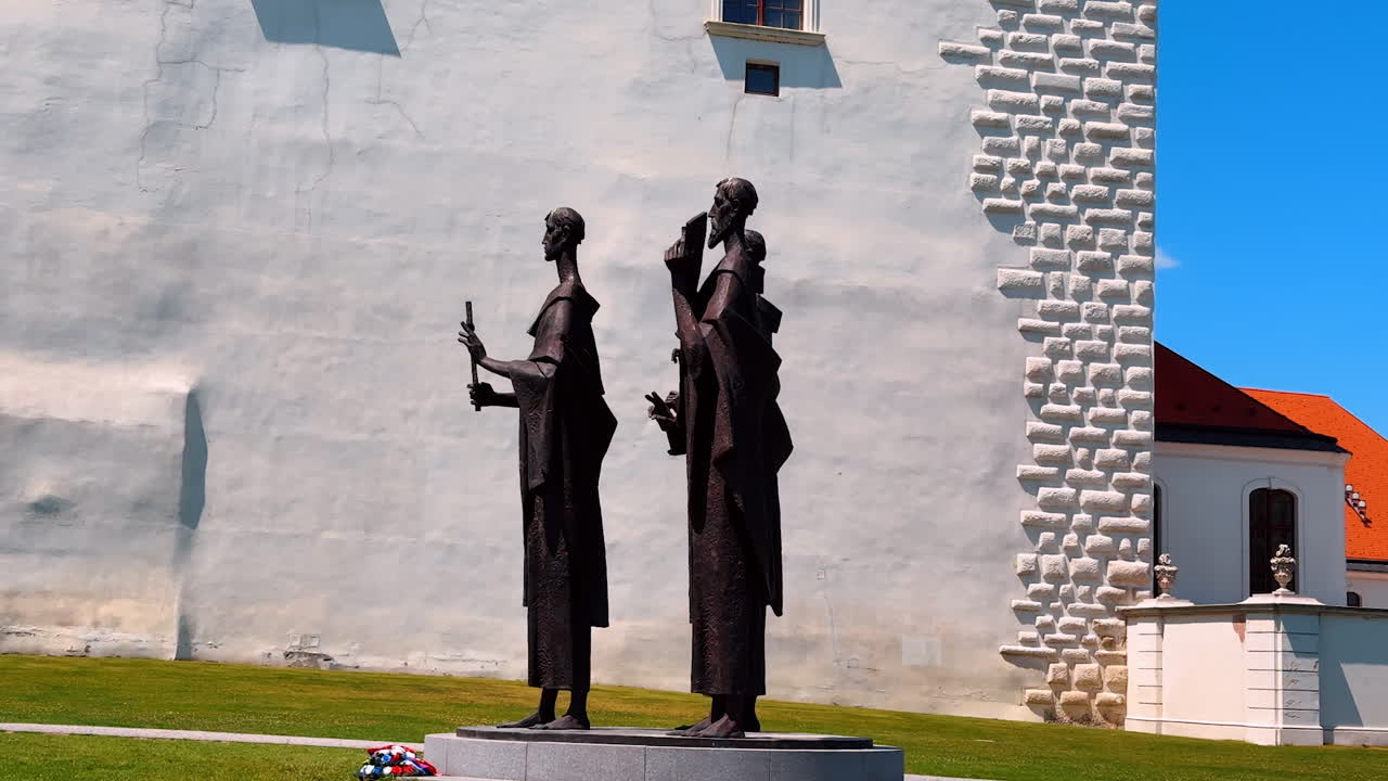 Monuments of three people near the white wall. Memorials of Bratislava Castle, Slovakia