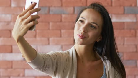 pretty brunette taking selfie