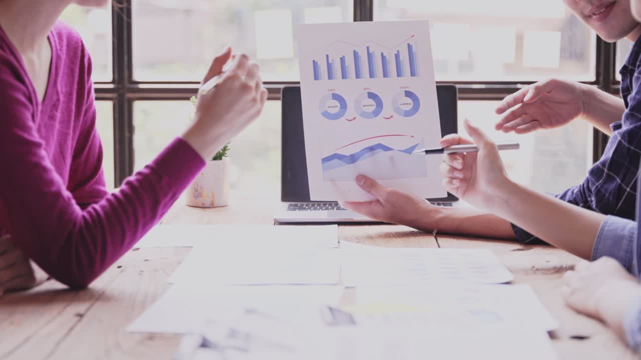 asian women Discussing budget plans, reports, chart concepts, graphs, paperwork data on laptop, tablet, at desk, office table. tax credit career consultant stock broker or market