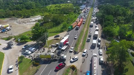 Aerial-view-overlooking-a-queue-of-cars,-traffic-Jam-due-to-a-truck-accident,-passenger-vehicle-crushed-under-a-truck,-in-San-Diego,-California,-USA,-America---tracking,-drone-shot