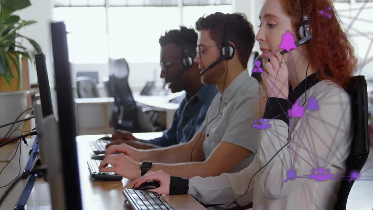 IT support team typing on keyboards wearing headsets in office showing purple network overlay