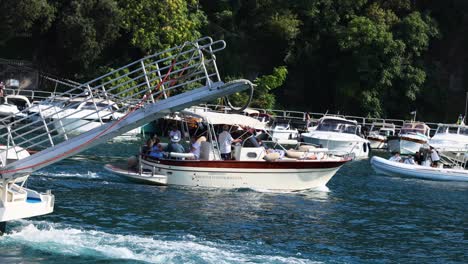 ferry docking as speed boat passes by