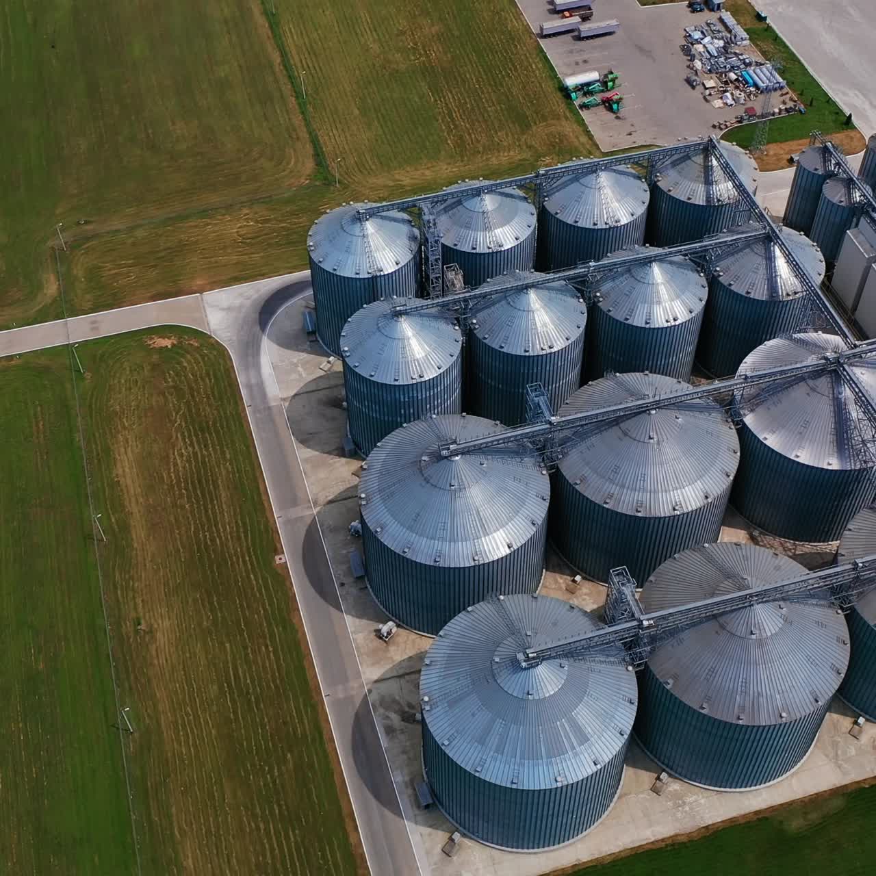 Huge tanks for processing and storage of wheat grain. Harvesting, processing and storage elevator for the crops. Aerial view