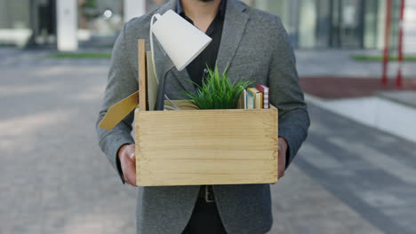 man leaving with his belongings in a wooden box