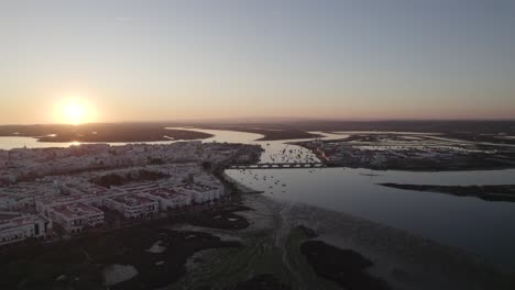 Aerial-establishing-shot-of-Magical-river-Landscape-of-Isla-Cristina-at-sunset,-Spain