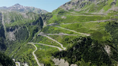scenic winding mountain pass, sharp turns, lush alpine landscape, switzerland