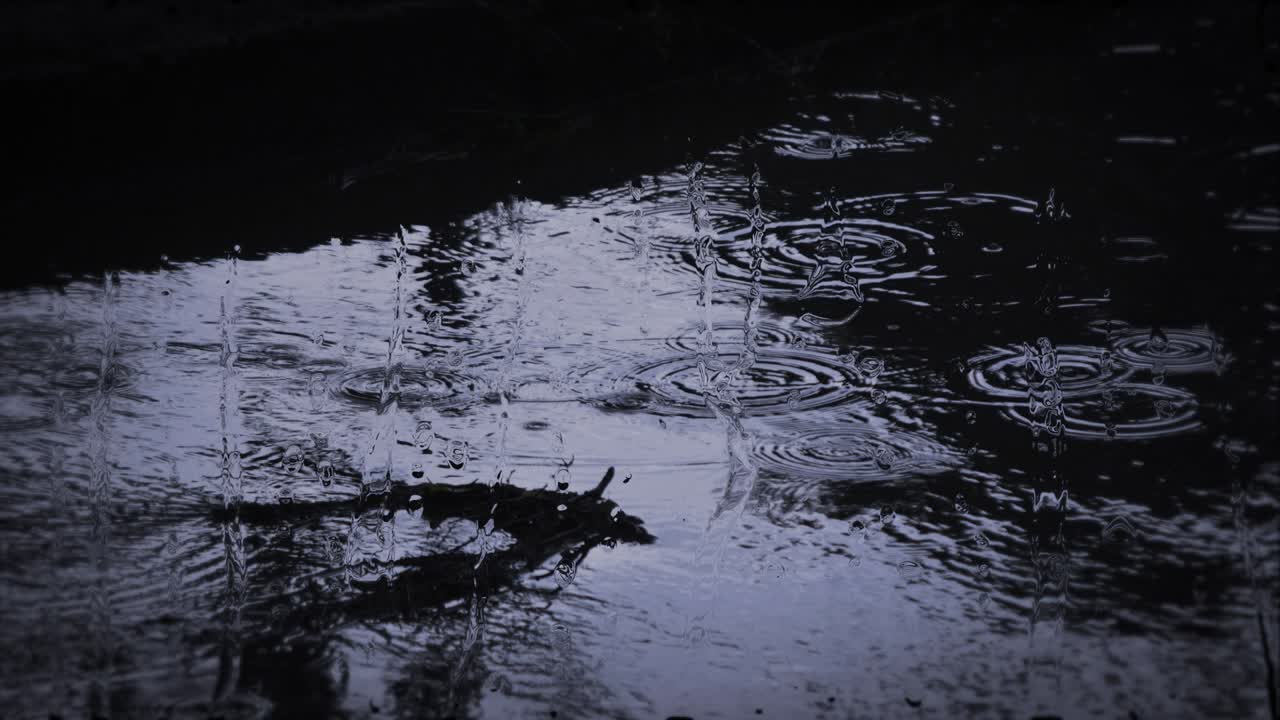 Heavy rain shower downpour cloudburst rainfall behind the glass.