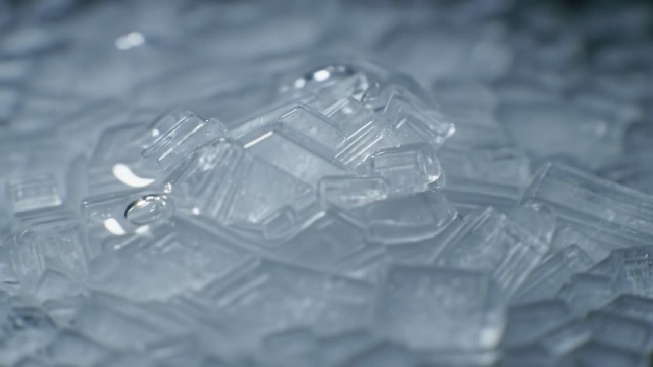 A Close-Up Exploration of Intricate Ice Crystal Formations, Capturing the Beautiful Patterns and Textures of Nature's Frozen Artistry Under Vibrant Light