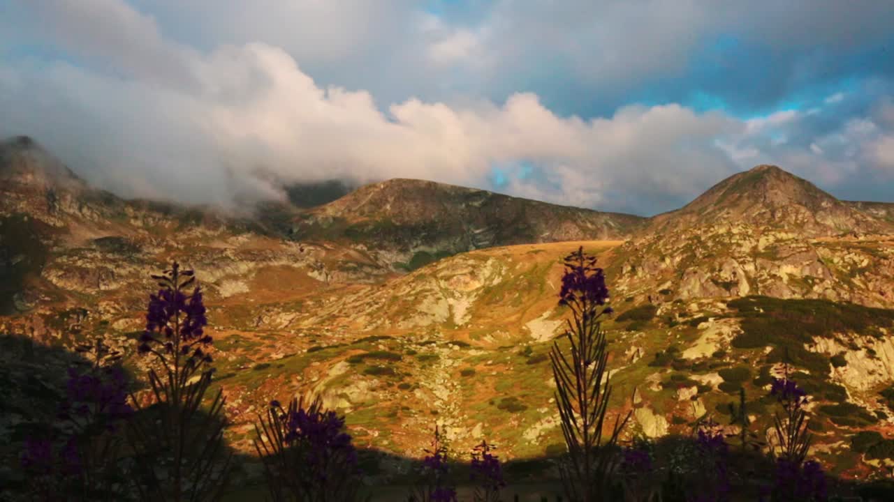 View of mountains during the golden hour with clouds